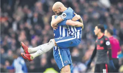  ?? Picture: AFP ?? EUPHORIC. Brighton defender Bruno Saltor leaps into the arms of team-mate Shane Duffy after beating Arsenal 2-1 in the English Premier League at the Amex Stadium yesterday.