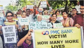  ?? PHOTO: PTI ?? PMC Bank account holders outside the Reserve Bank office in Mumbai on Tuesday
