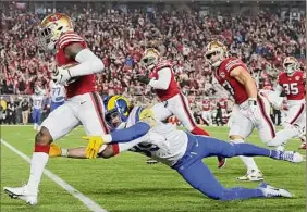  ?? Ezra Shaw / Getty Images ?? Jimmie Ward of the 49ers intercepts a pass intended for Tyler Higbee of the Rams during the first quarter Monday. The game didn’t end in time for this edition. Go to timesunion.com for a complete report.