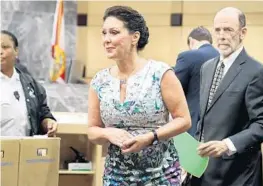  ?? AMY BETH BENNETT/STAFF PHOTOGRAPH­ER ?? Former Hallandale Beach Mayor Joy Cooper, charged with corruption, leaves the courtroom at the Broward County Courthouse with her attorney Larry Davis.