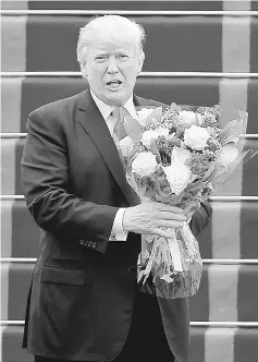  ?? — Reuters photo ?? Trump at the stairs of the Air Force One plane before departing from Noi Bai internatio­nal airport, in Hanoi, Vietnam.