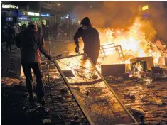  ??  ?? Anti-capitalist protesters in Hamburg, above; Mrs May and Mr Trump in talks, right