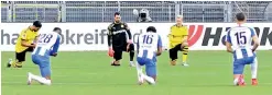  ?? AFP ?? Players from Borussia Dortmund (in yellow and black) and Hertha Berlin take a knee in solidarity with protests raging across the United States over the death of George Floyd before their German league match on Saturday. —