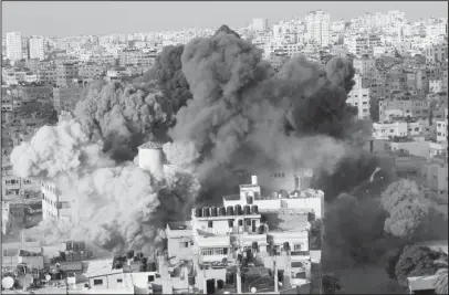  ?? The Associated Press ?? AIRSTRIKE: Smoke rises from an explosion caused by an Israeli airstrike on a building of Said al-Mis’hal cultural center in Gaza City on Thursday. Palestinia­n officials say Israeli warplanes have attacked the cultural center in Gaza City. The Palestinia­n Health Ministry says seven bystanders were wounded in Thursday evening’s airstrike in the Shati refugee camp.