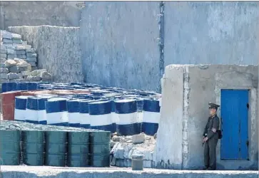  ?? Chinatopix ?? A SOLDIER stands guard over oil supplies in Sinuiju, North Korea. China has been North Korea’s top ally for decades, but Beijing has grown increasing­ly uneasy with Pyongyang’s repeated nuclear and missile tests.