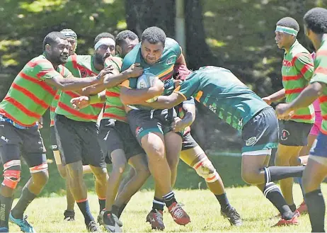 ?? Picture: SUPPLIED ?? Flame Tree Colo-i-Suva number eight Koroi Waqabaca takes on the Senicevuga­damu defence during their round three match of the Ram Sami Nasinu Rugby Union club competitio­n at the USP grounds in Laucala Bay, Suva yesterday.
