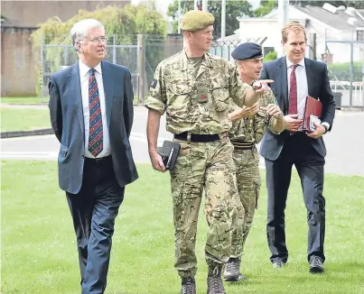  ?? Picture: Mark Owens. ?? Sir Michael Fallon, as defence secretary, is shown around Leuchars Station by the Commander of Stirling-based 51 Infantry Brigade, Brigadier Gary Deakin.