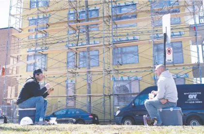  ?? PAUL CHIASSON/THE CANADIAN PRESS ?? Constructi­on workers take their lunch break in Montreal last week. While industry groups are supportive of the federal government’s spending plans, they say the feds should not prescribe what types of projects get built when stimulus is the priority.