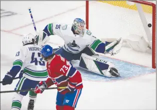  ?? CP PHOTO RYAN REMIORZ ?? Montreal Canadiens right wing Tyler Toffoli (73) scores on Vancouver Canucks goaltender Thatcher Demko (35) as Canucks defenceman Quinn Hughes (43) looks on during second period NHL hockey action Tuesday in Montreal.