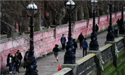  ?? ?? People walk past the National Covid Memorial Wall in London on Wednesday. Photograph: Andy Rain/EPA