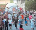 ??  ?? Runners are chased down the streets of Mataelpino by a giant white ball