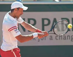  ?? SUSAN MULLANE/USA TODAY SPORTS ?? Novak Djokovic hits a return against Stefanos Tsitsipas in the French Open final June 13 in Paris.