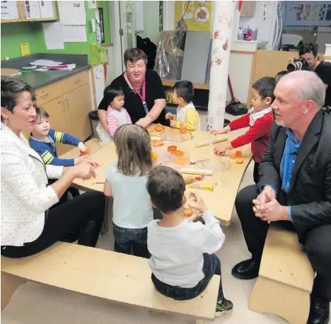  ?? ADAM FOSTER/FILES ?? John Horgan, seen with MLA Melanie Mark at the Terry Tayler Early Learning and Care Centre in east Vancouver last October, campaigned on a promise of universal $10-a-day child care. Green Leader Andrew Weaver says the premier’s campaign promises are...