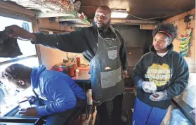  ?? JIM WEBER / THE COMMERCIAL APPEAL ?? Antonio Chew gets help from his children Antonio, left, and Monique Chew at his Grill Master Chew food truck selling lunches at the new Memphis Food Truck Park on Winchester.