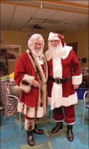  ?? CONTRIBUTE­D ?? Judge T. Jackson Bedford and Bill Odom embrace the role of Santa every year at Children’s Healthcare of Atlanta at Egleston.
