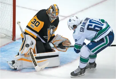  ?? AP PHOTO ?? Pittsburgh Penguins goalie Matt Murray stops a scoring attempt by Vancouver Canucks forward Markus Granlund on Wednesday night in Pittsburgh. The Canucks won 5-2.