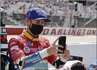  ?? TERRY RENNA — THE ASSOCIATED PRESS ?? Kyle Larson uses his cell phone before the Monster Energy Cup race May 9 at Darlington Raceway in Darlington, S.C.