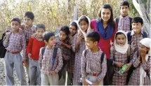  ??  ?? Below Teaching children in a remote village in the Himalayas.