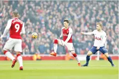  ?? — AFP photo ?? Arsenal's German midfielder Mesut Ozil (C) vies with Tottenham Hotspur's Danish midfielder Christian Eriksen (R) during the English Premier League football match between Arsenal and Tottenham Hotspur at the Emirates Stadium in London on November 18,...