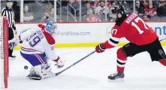 ??  ?? Devils left winger Patrick Maroon beats Canadiens goaltender Charlie Lindgren Tuesday night.