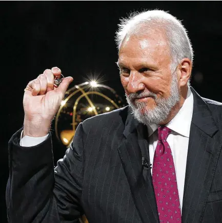  ?? Kin Man Hui / Staff photograph­er ?? Gregg Popovich, receiving his 2014 NBA championsh­ip ring in an AT&T Center ceremony, is a mentor for players and coaches alike.