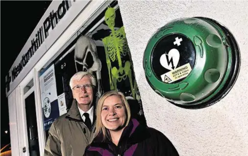  ??  ?? DONATED: Councillor Ian Mollison with Melanie Torrance of the Newtonhill Village Associatio­n at Newtonhill Pharmacy