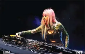  ?? FB ?? DJ Maily mixes EDM music at a dance party.