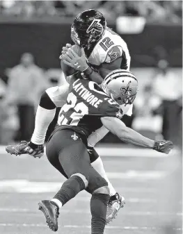  ?? AP Photo/Butch Dill ?? New Orleans Saints cornerback Marshon Lattimore (23) hits Atlanta Falcons wide receiver Mohamed Sanu (12) on a pass reception in the second half Sunday in New Orleans.