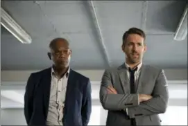  ?? JACK ENGLISH — LIONSGATE VIA AP ?? This image released by Lionsgate shows Samuel L. Jackson, left, and Ryan Reynolds in “The Hitman’s Bodyguard.”
