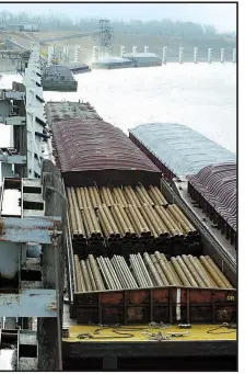  ?? Arkansas Democrat-Gazette archive photo ?? Barges are ready for use at the Tulsa Port of Catoosa, Okla., the end of the Kerr-McClellan Navigation System.