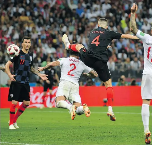  ?? — GETTY IMAGES ?? Croatia’s Ivan Perisic gets his foot in front of a clearance attempt from England’s Kyle Walker to score the game-tying goal in the second half of yesterday’s semifinal. Croatia won the game 2-1.