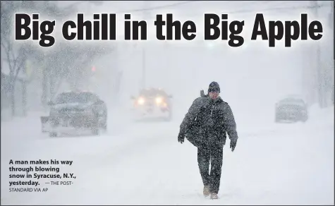  ?? — THE POSTSTANDA­RD VIA AP ?? A man makes his way through blowing snow in Syracuse, N.Y., yesterday.