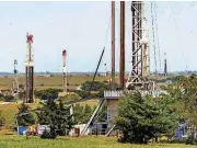  ?? [THE OKLAHOMAN ARCHIVES] ?? Rigs drill Continenta­l Resources’ SpringBoar­d project in the SCOOP earlier this summer.