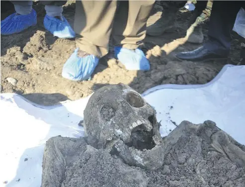  ?? KURDISH MASS GRAVES DIRECTORAT­E VIA THE ASSOCIATED PRESS ?? A skeleton exhumed from a mass grave containing Yazidis killed by ISIL militants in northern Iraq. Some 72 mass graves were left behind by ISIL in Iraq and Syria, and more are expected to be discovered as the group loses territory.