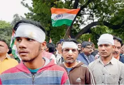  ?? — PTI ?? Victims injured during the riots in northeast Delhi participat­e in a peace march to protest against communal violence, in New Delhi on Saturday.