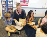  ??  ?? Alicia Sanchez reads to her son, Joey Lee, on the first day of prekinderg­arten last month at Tesuque Elementary School.