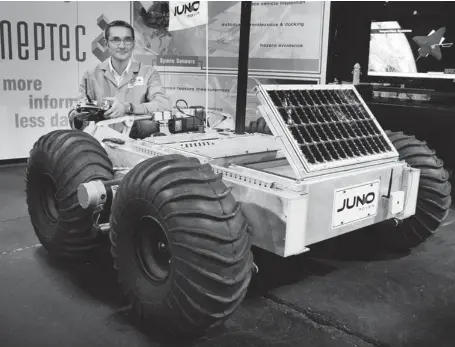  ?? CHRIS MIKULA / OTTAWA CITIZEN FILES ?? Neptec’s Juno Rover, demonstrat­ed by Doug Aikman, is a robot capable of operating on other planets. It’s the sort of technology Canadians can produce.