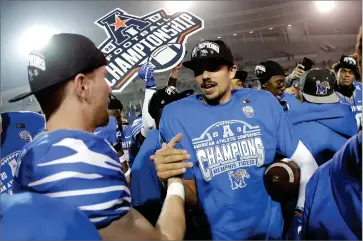  ?? AP PHOTO BY MARK HUMPHREY ?? In this Dec. 7, 2019, file photo, Memphis quarterbac­k Brady White, center, celebrates after his team defeated Cincinnati in an NCAA college football game for the American Athletic Conference championsh­ip, in Memphis, Tenn. The American Athletic Conference will require all its schools to test football players for COVID-19 at least 72 hours before competitio­n.