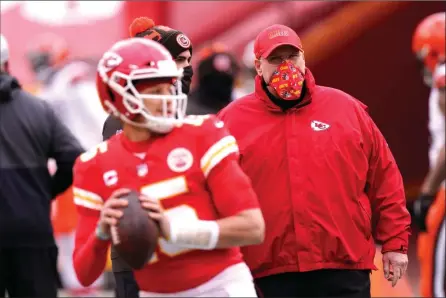  ?? The Associated Press ?? Kansas City Chiefs head coach Andy Reid, right, watches quarterbac­k Patrick Mahomes warm up before an NFL divisional round football game against the Cleveland Browns in Kansas City on Jan. 16.