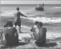  ?? AP PHOTO ?? In this photo released by the Libyan coast guard, African migrants who were found on a damaged rubber boat in the Mediterran­ean Sea and rescued by the Libyan coast guard arrive to shore, east of the capital, Tripoli, Libya.