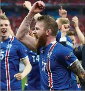  ??  ?? GUNNING FOR GLORY: Aron Gunnarsson leads the celebratio­ns as Iceland reach the last 16