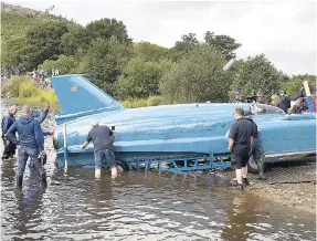  ?? AP ?? The restored Bluebird K7, which crashed killing pilot Donald Campbell in 1967, takes to the water for the first time in more than 50 years off the Isle of Bute on the west coast of Scotland yesterday.