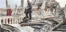  ?? — AFP ?? A man inspects the rubble of a building destroyed by bombardmen­t, in Rafah.