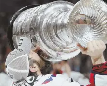  ?? AP PHOTO ?? TASTE OF SUCCESS: Alex Ovechkin kisses the Stanley Cup following the Capitals victory Thursday night.