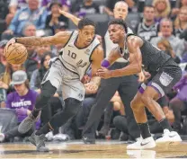  ?? Rich Pedroncell­i / Associated Press ?? Spurs guard DeMar DeRozan, left, drives against Kings guard Buddy Hield on his way to a team-high 23-point game on Monday night.