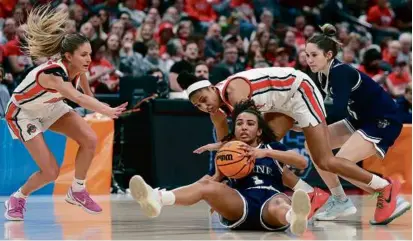  ?? KIRK IRWIN/GETTY IMAGES ?? Maine’s Olivia Rockwood won this scramble, but Ohio State secured an 80-57 first-round win.