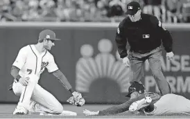  ?? [AP PHOTO] ?? Chicago Cubs’ Jon Jay slides in safely to second base with a double as Washington Nationals shortstop Trea Turner, left, makes a late tag during the first inning of Game 5 of the National League Division Series in Washington.