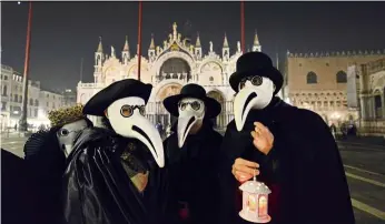  ??  ?? Participan­ts in the ‘Plague doctors Procession’ at Saint Mark Square in Venice on Feb 25, wear replicas of the beaked face masks doctors wore in the Middle ages to avoid contractin­g the bubonic plague. — aFP