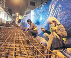 ?? ARNUN CHONMAHATR­AKOOL ?? Labourers work on steel rods at a skytrain extension in Bangkok.