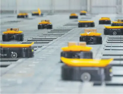  ??  ?? SILICONE SHIPPING. Automated sorting robots carry packages at the express sorting centre of STO Express Tianjin company in Tianjin, China.